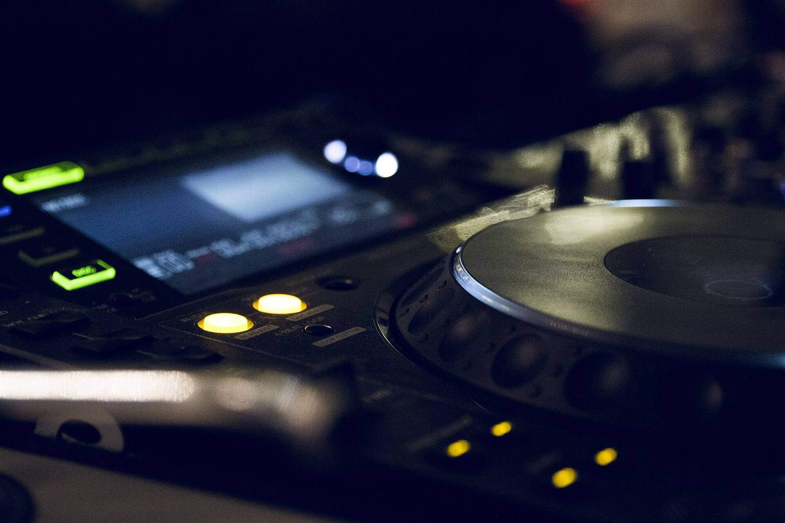 Close-up of a DJ deck with illuminated controls