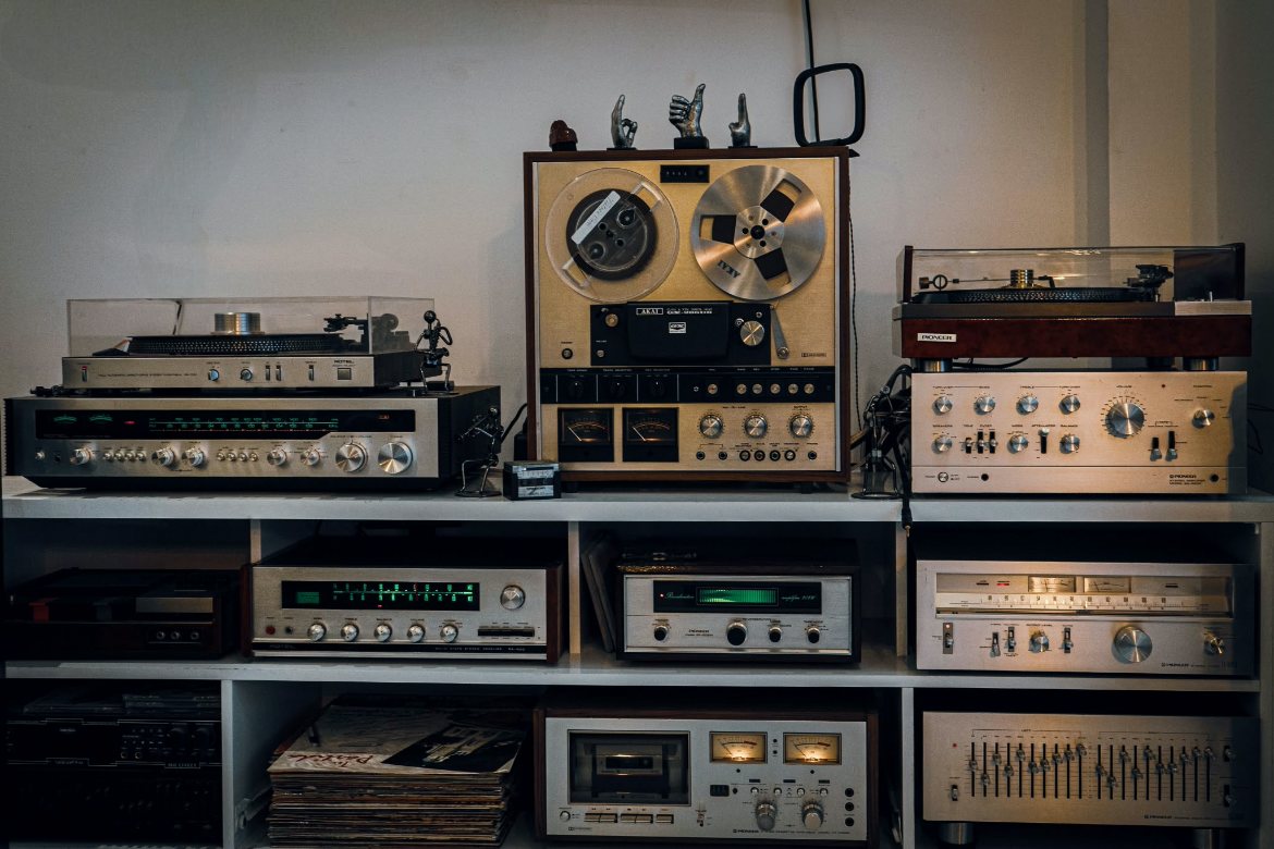 Vintage hi-fi separates, turntables and a reel-to-reel deck on a shelf