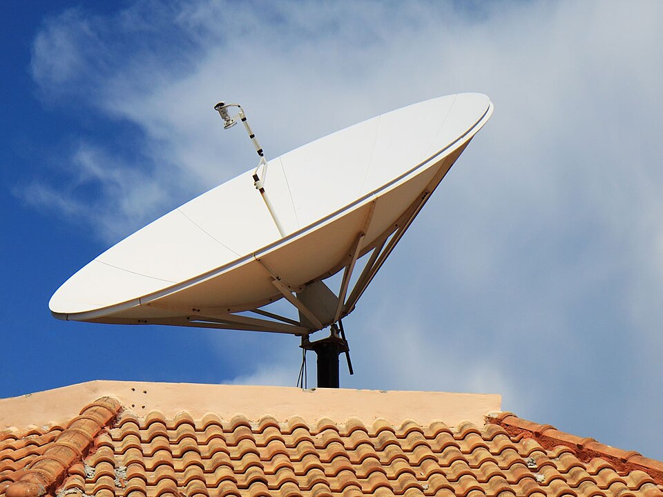 Satellite dish on a tiled house roof